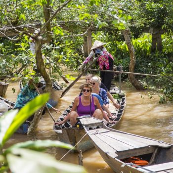 People Sailing through mekong river jungle