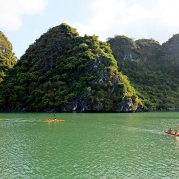 Kayaking in Halong Bay near beautiful exotic rocks