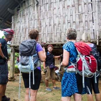 Tourist finally arrives at traditional village homestay after a long day of trekking